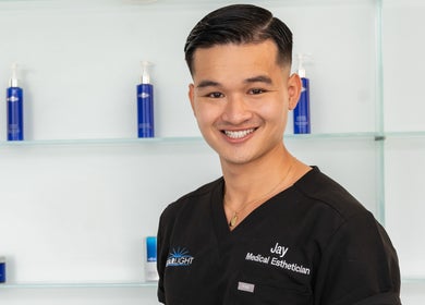 Expert esthetician at Starlight Med Spa Toronto, Ontario, CA, showcasing skincare products.