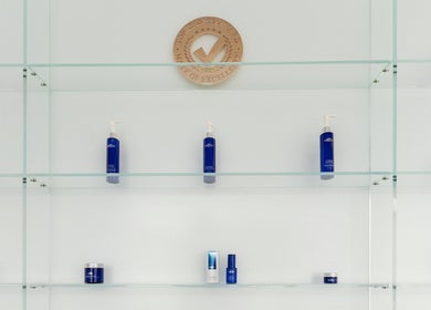 Glass shelves with blue skincare products at Starlight Med Spa Toronto, Ontario, CA enhancing elegance.