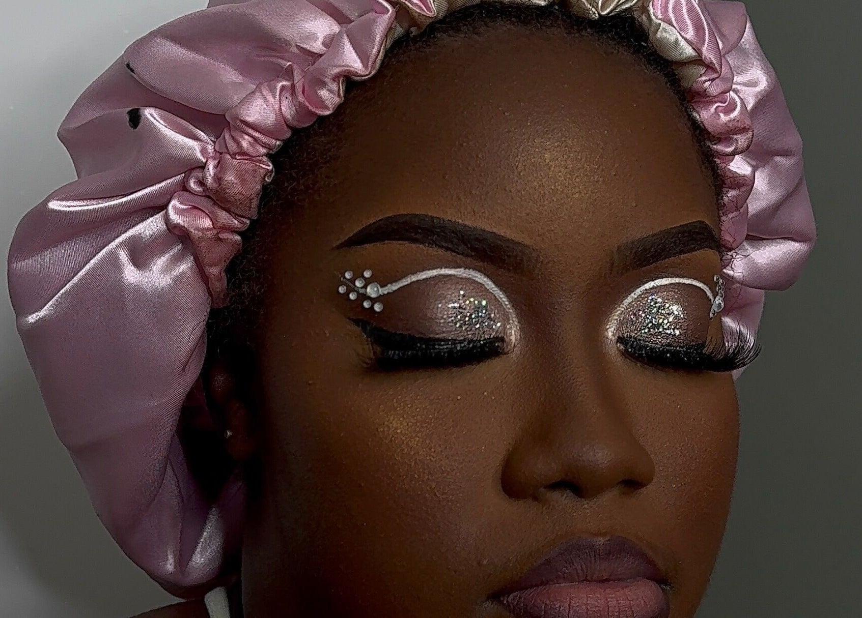 Close-up of intricate eye makeup at Essence Oasis Salon and Spa, Saint John's, AG, showcasing artistry.