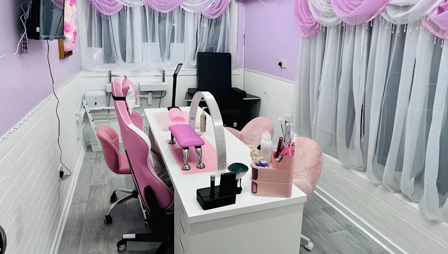 Elegant nail salon at Cariad Beauty, Fauldhouse, Scotland, GB featuring pink decor and chic furniture.