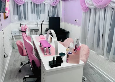 Elegant nail salon at Cariad Beauty, Fauldhouse, Scotland, GB featuring pink decor and chic furniture.