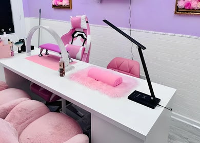 Stylish nail salon at Cariad Beauty, Fauldhouse, Scotland, GB with chic pink decor and professional equipment.
