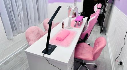 Modern nail station at Cariad Beauty in Fauldhouse, Scotland, GB with pink chairs and sleek decor.