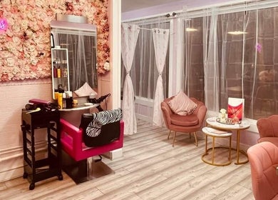 Elegant interior of Cariad Beauty, Fauldhouse, Scotland, GB, featuring plush chairs and floral decor.
