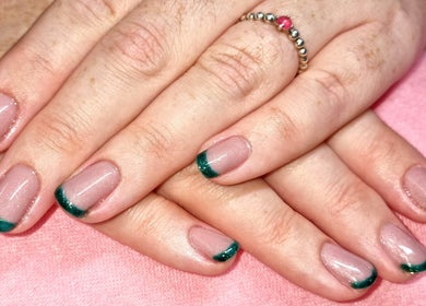 Green-tipped manicured nails at Cariad Beauty, Fauldhouse, Scotland, GB, showcasing elegance and style.