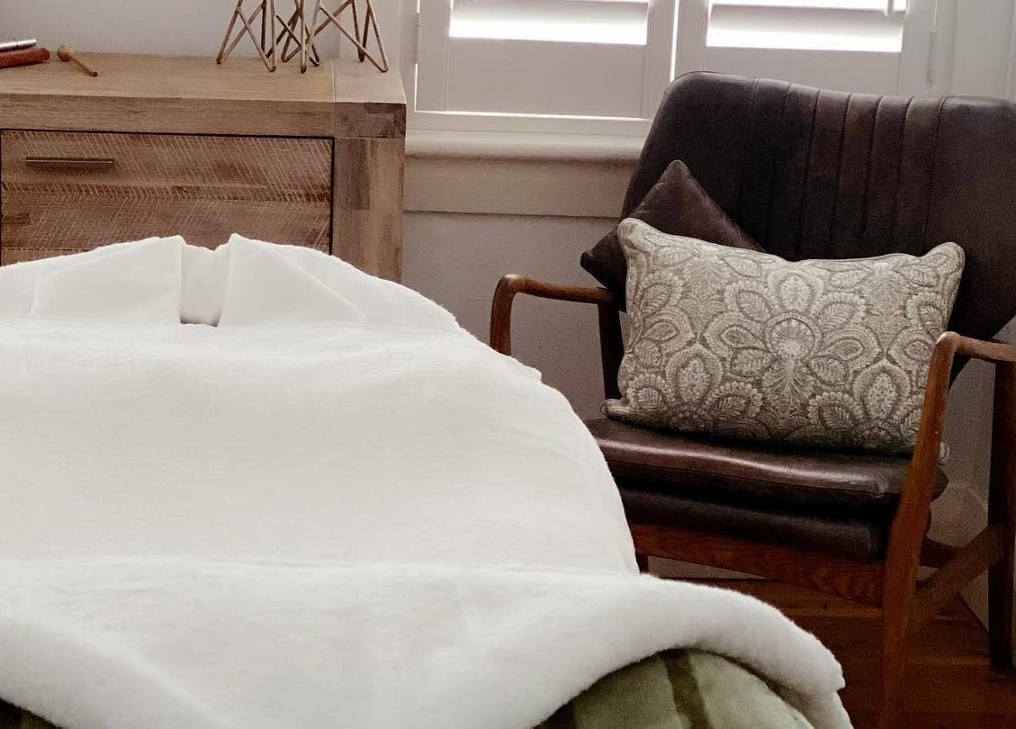 Luxurious massage room at Circa 1929, Wagga Wagga, New South Wales, AU, featuring plush chair and cozy decor.