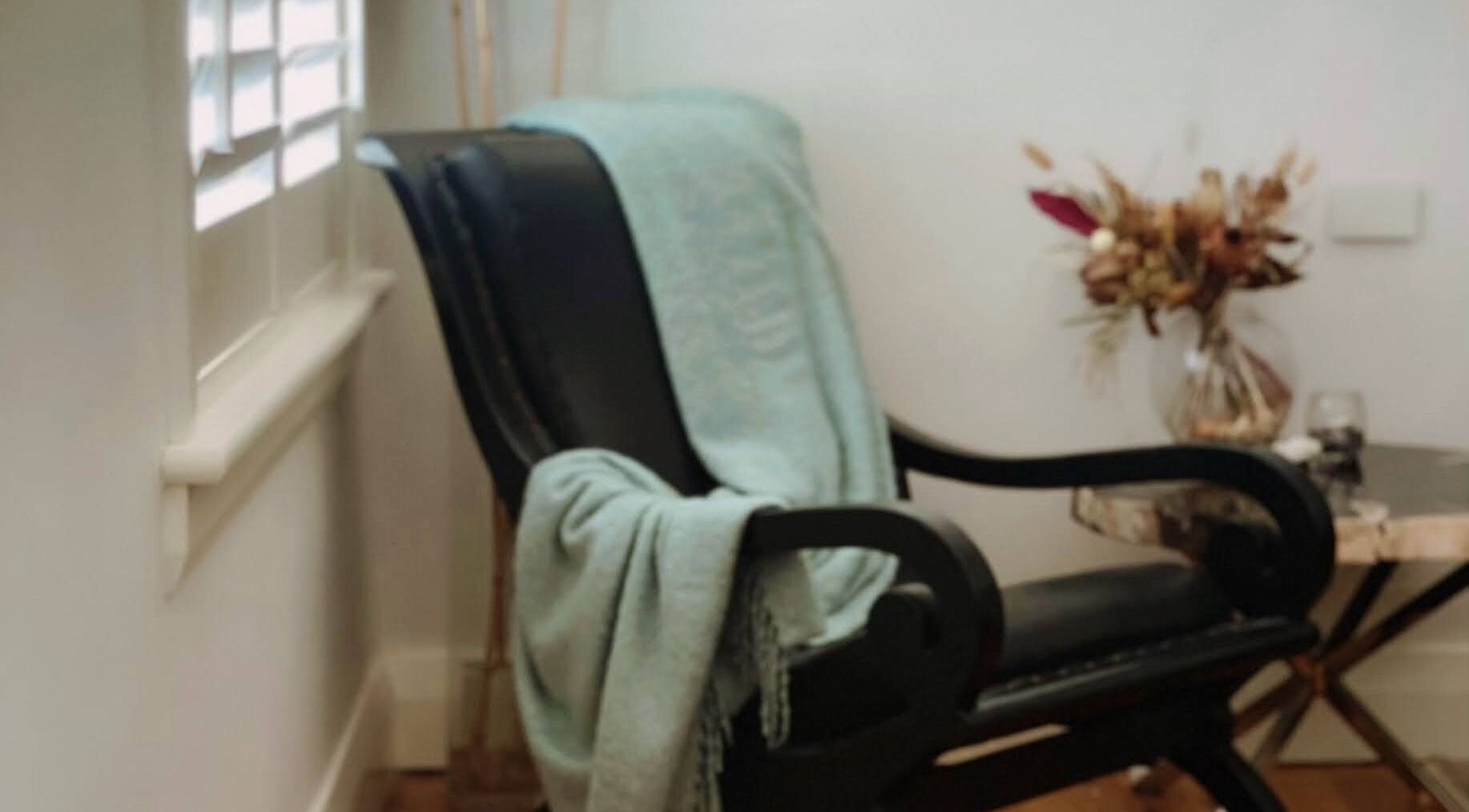 Relaxing chair with a soft throw at Circa 1929, Wagga Wagga, New South Wales, AU. Ideal for wellness retreats.