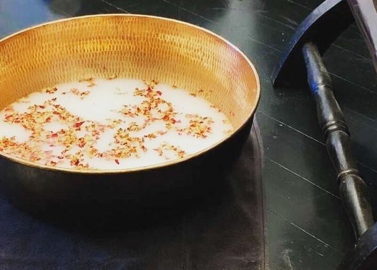 A brass bowl with petals at Circa 1929, Wagga Wagga, New South Wales, AU offers a serene spa atmosphere.