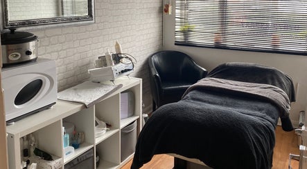 Relaxing treatment room at Hills Beauty Room in Runcorn, England, GB, featuring a massage bed and beauty equipment.