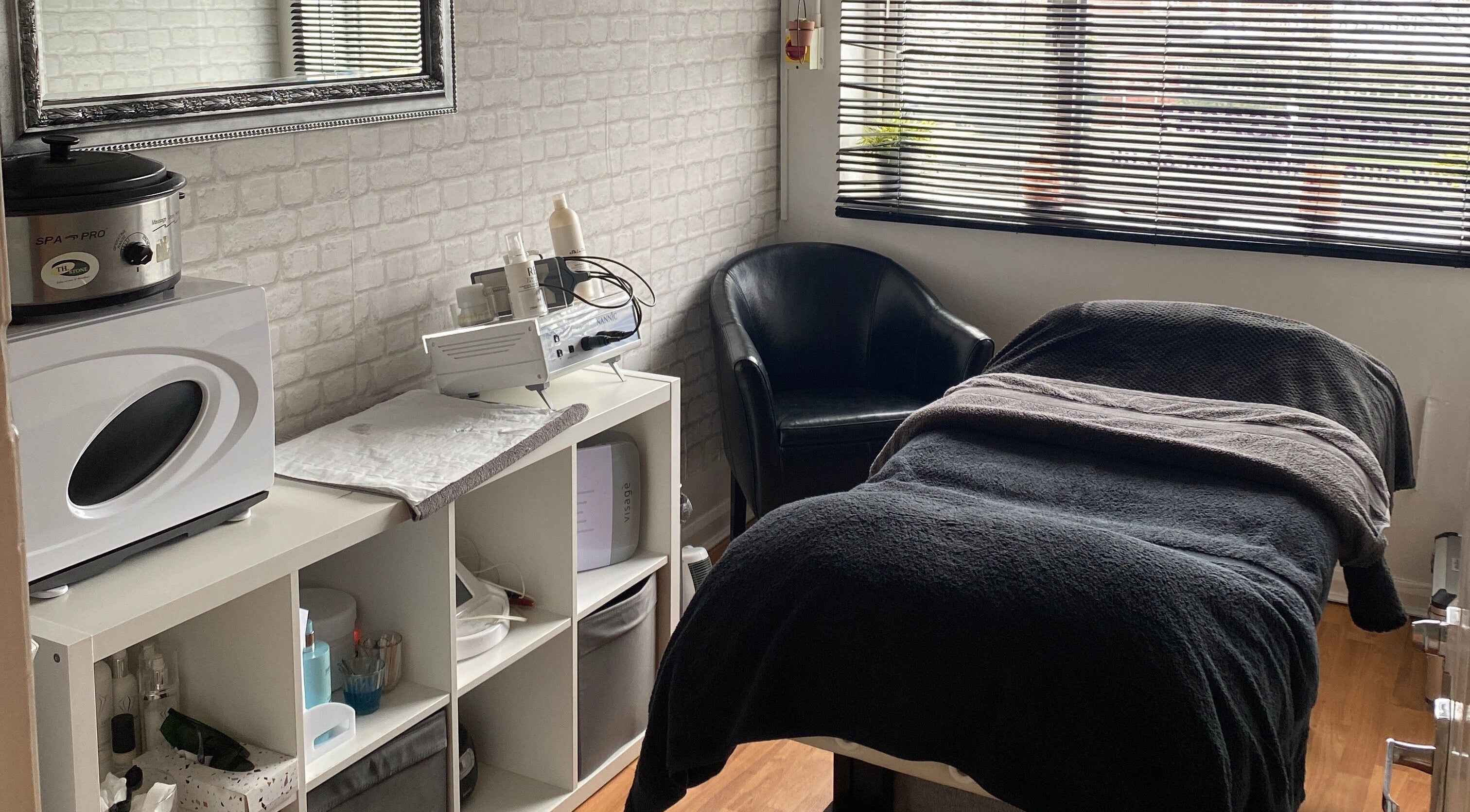 Cozy treatment room at Hills Beauty Room, Runcorn, England, GB, featuring a massage bed and skincare equipment.