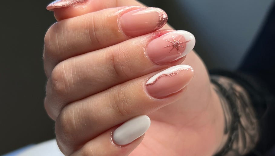 Glittering manicure at Danii Nails, Bowden, South Australia, AU. Features pink and white nails with star detail.