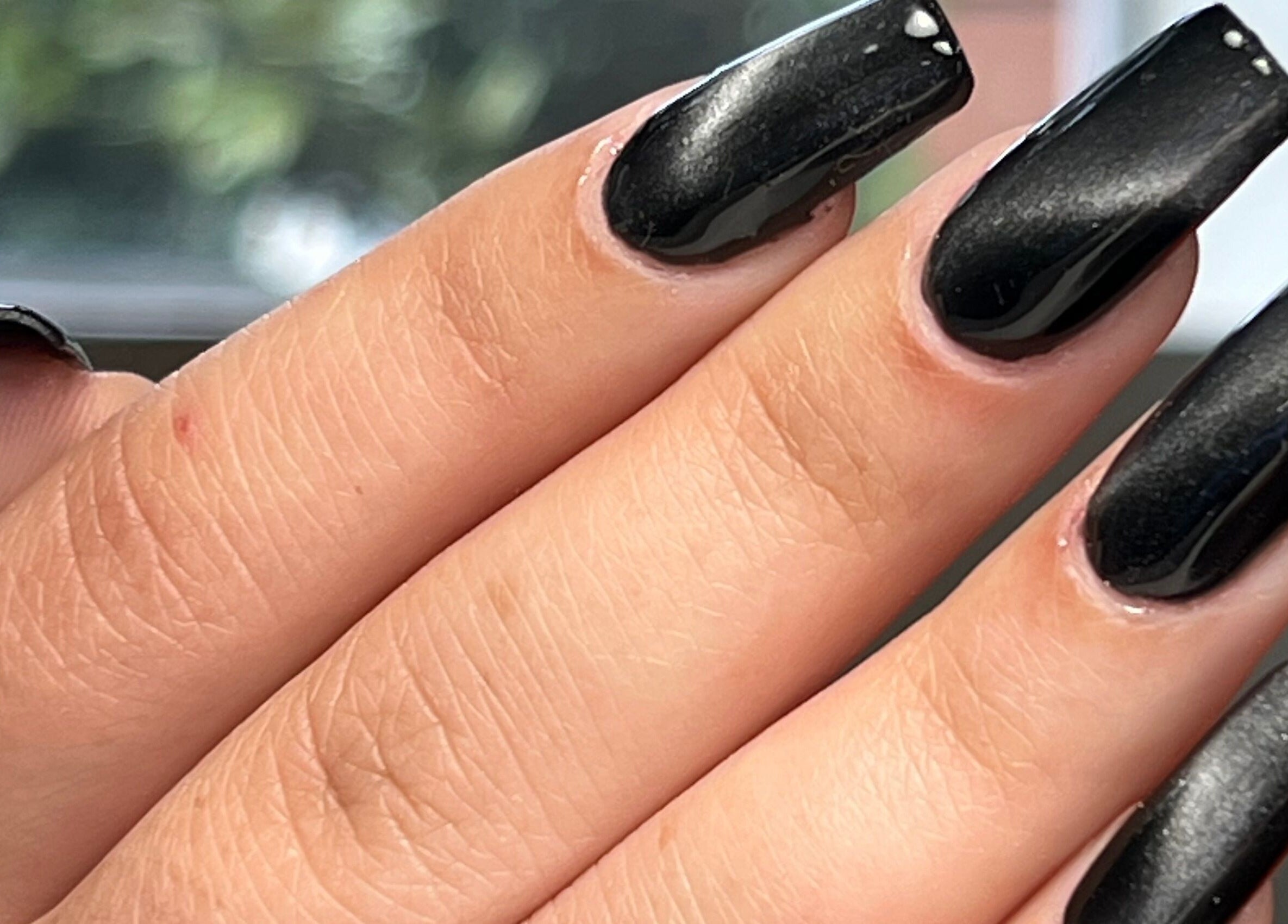 Close-up of glossy black nails at Danii Nails in Bowden, South Australia, AU, exemplifying elegance and style.