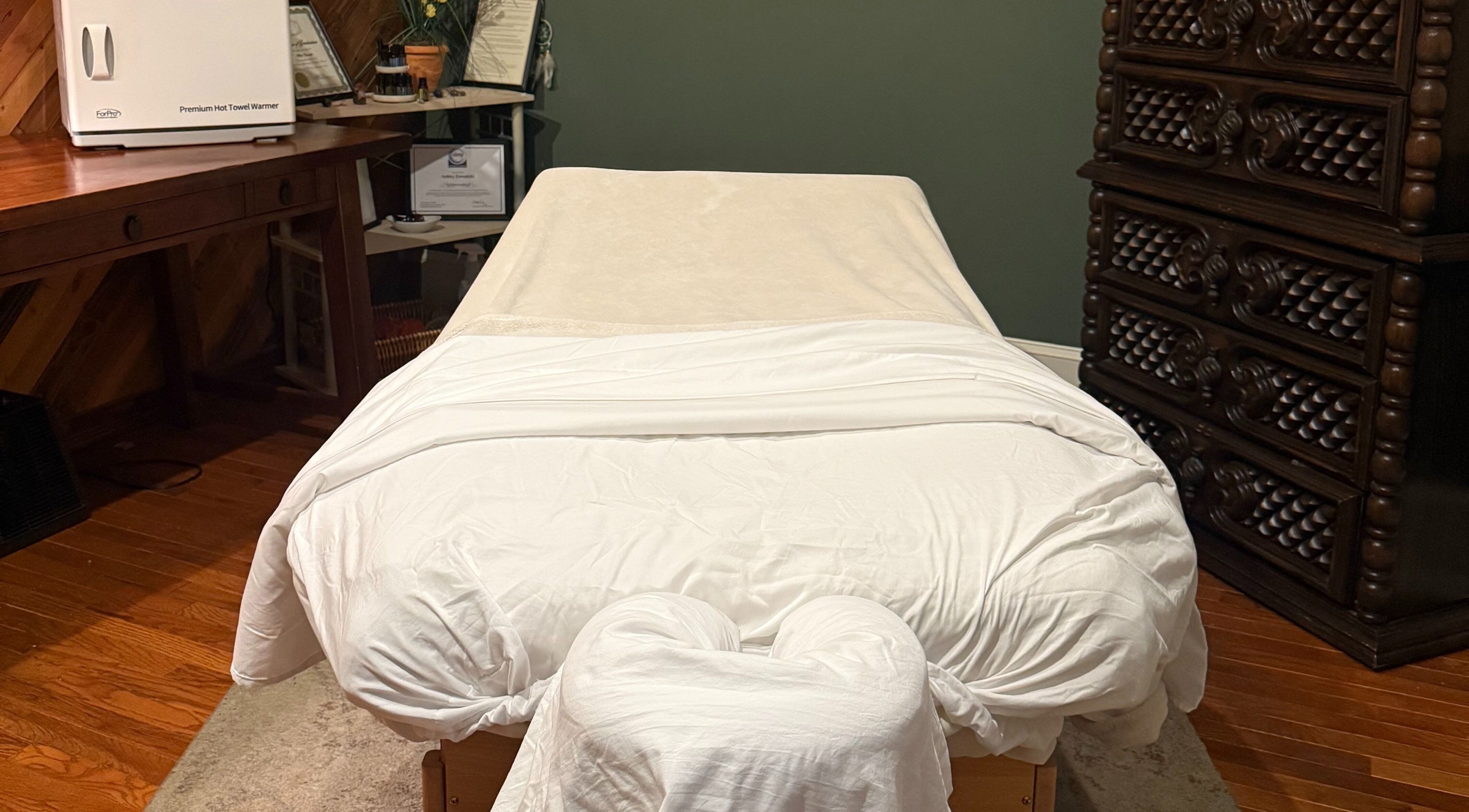 Cozy massage table at Mother Earth Spa, Romeo, Michigan, US, with warm decor.