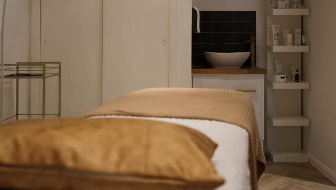 Massage table at Le Roux Beauty in Langford, England, GB, offering a serene spa experience.