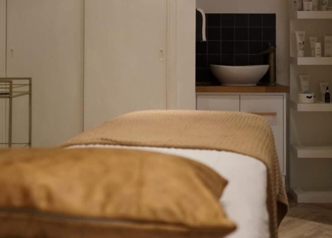 Massage table at Le Roux Beauty in Langford, England, GB, offering a serene spa experience.