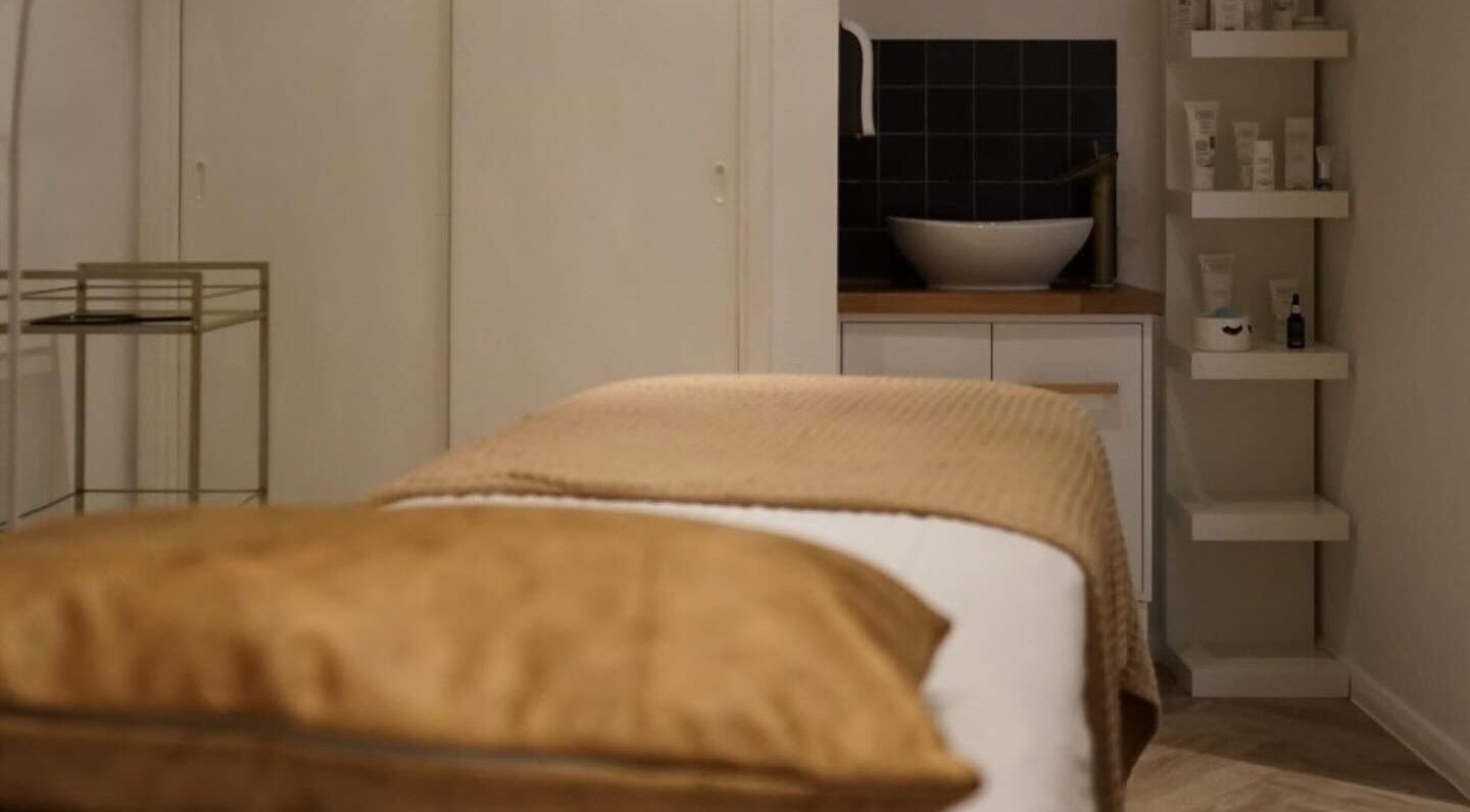 Massage table at Le Roux Beauty in Langford, England, GB, offering a serene spa experience.