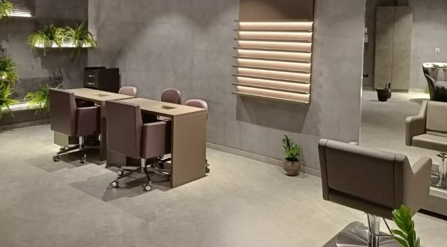 Spacious and modern interior of Beautiful New You Star Salon in Dubai, AE, featuring sleek furniture and greenery.