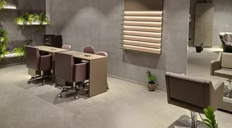 Spacious and modern interior of Beautiful New You Star Salon in Dubai, AE, featuring sleek furniture and greenery.