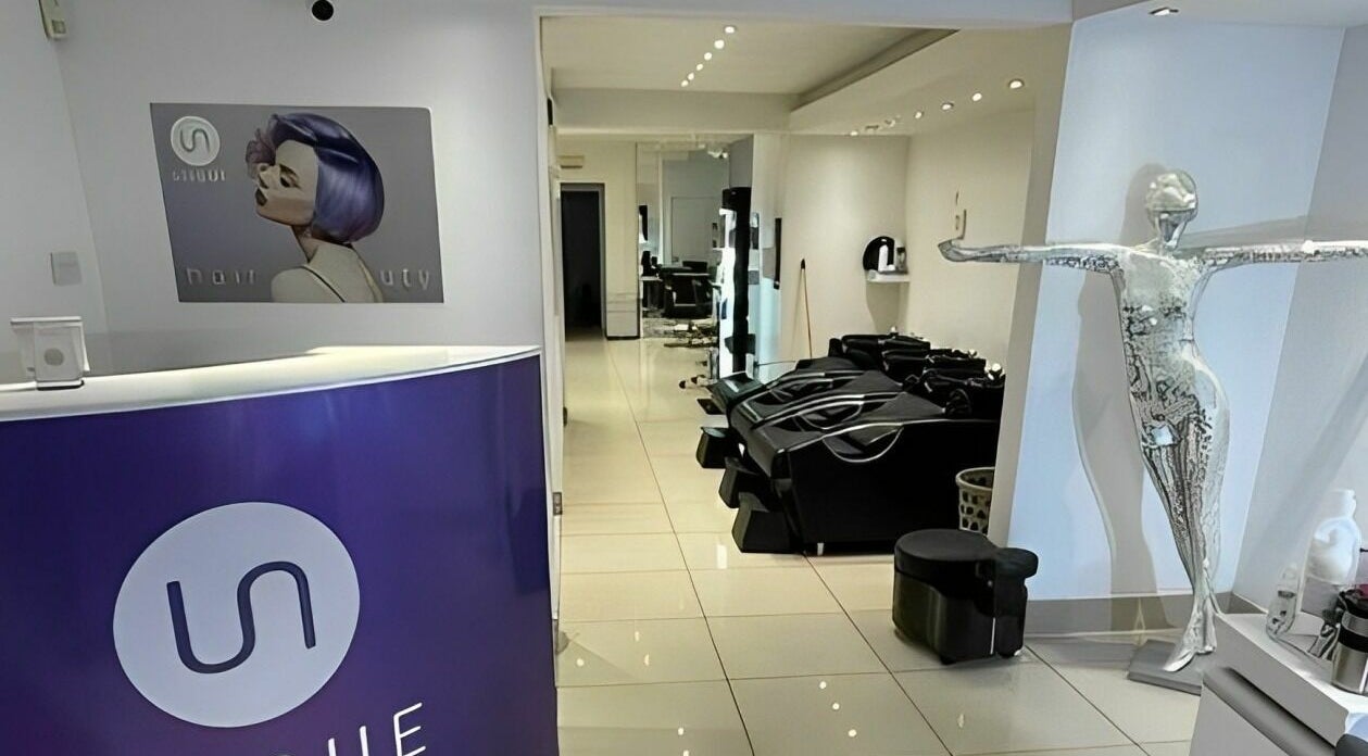 Interior of Unique Hair & Beauty in Hadleigh, England, GB featuring modern salon stations and decor.