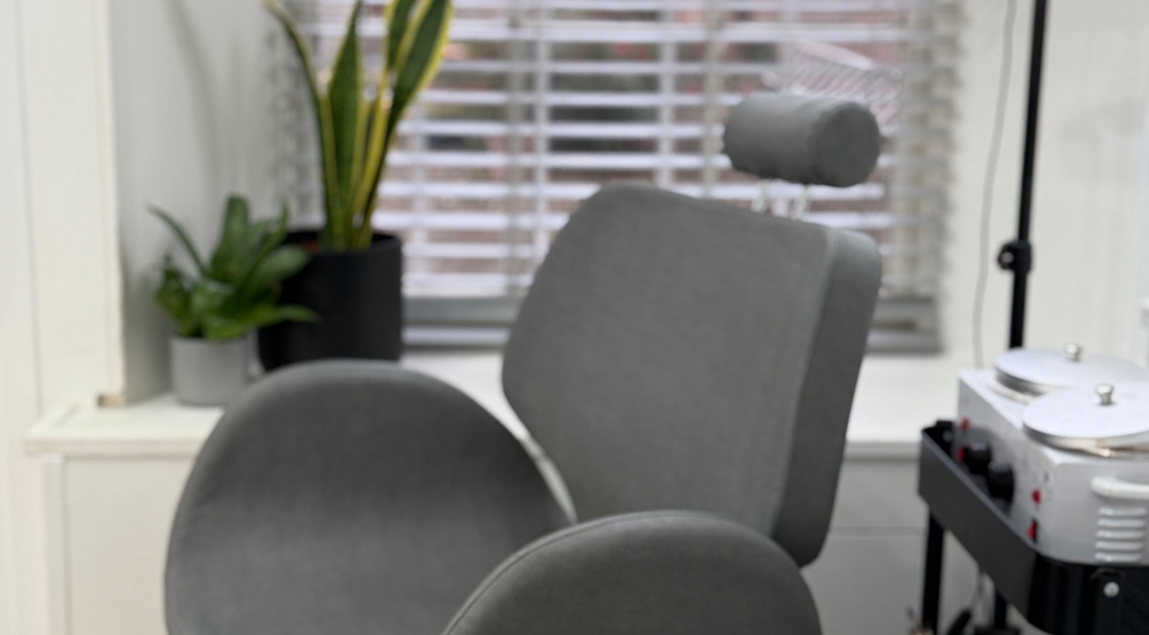 Comfortable treatment chair at Blossom Beauty in Forfar, Scotland, GB, with sleek decor and natural light.