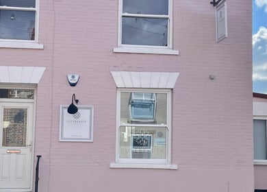 Front view of Pure Beauty & Skincare Roos in Roos, England, featuring a pastel pink exterior.