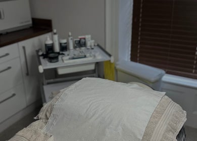 Tranquil treatment room at Pure Beauty & Skincare Roos, Roos, England, GB, with skincare products displayed.