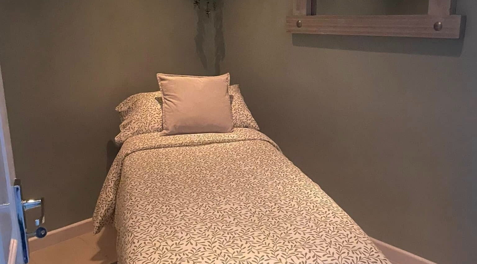 Cozy massage room with patterned bedding at Perfect Pressure in Crawcrook, England, GB, offering relaxation.