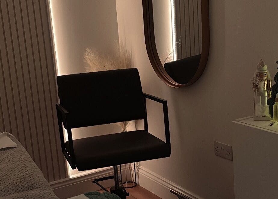 Cozy beauty treatment room at Nóvara, Rochford, England, GB with a chair and serene decor.