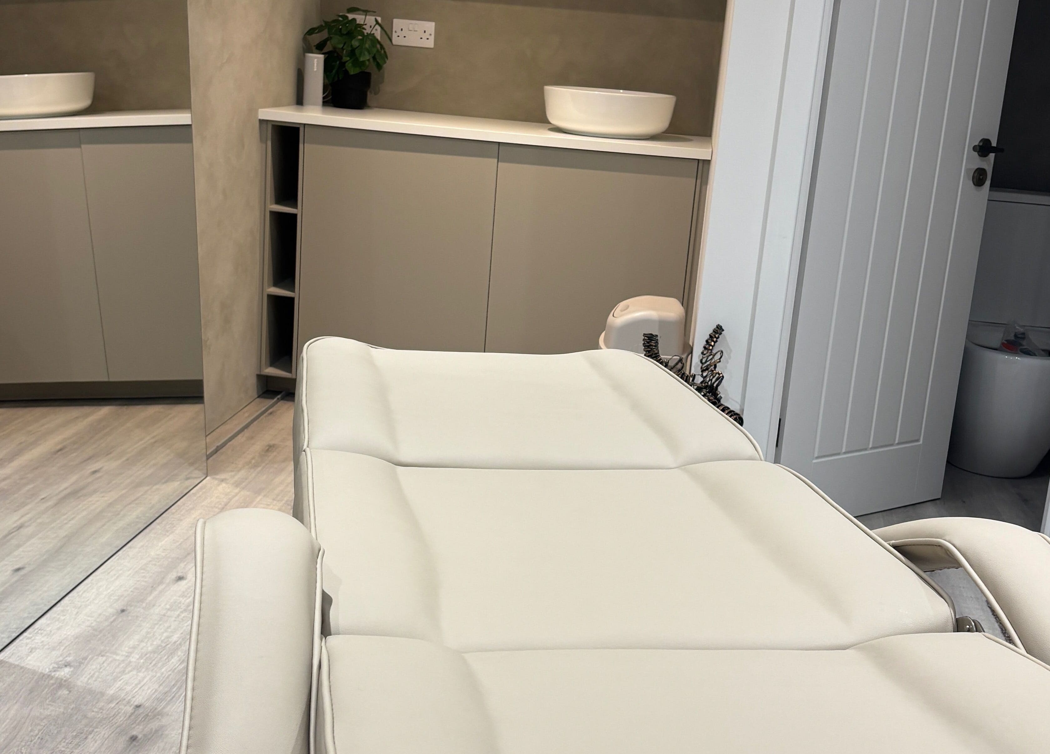 Luxurious treatment room at Nóvara in Rochford, England, GB featuring a plush reclining chair.