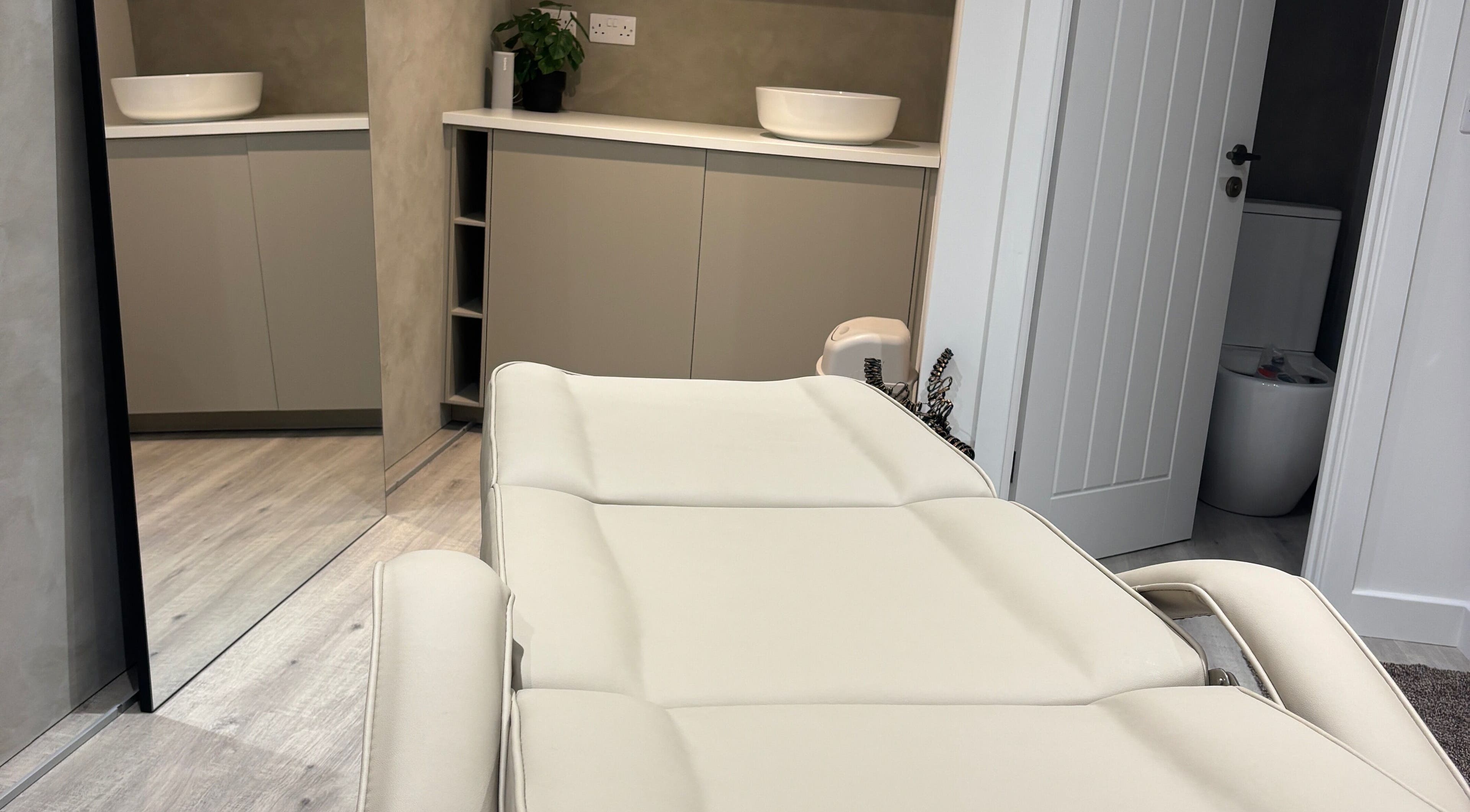 Luxurious treatment room at Nóvara in Rochford, England, GB featuring a plush reclining chair.
