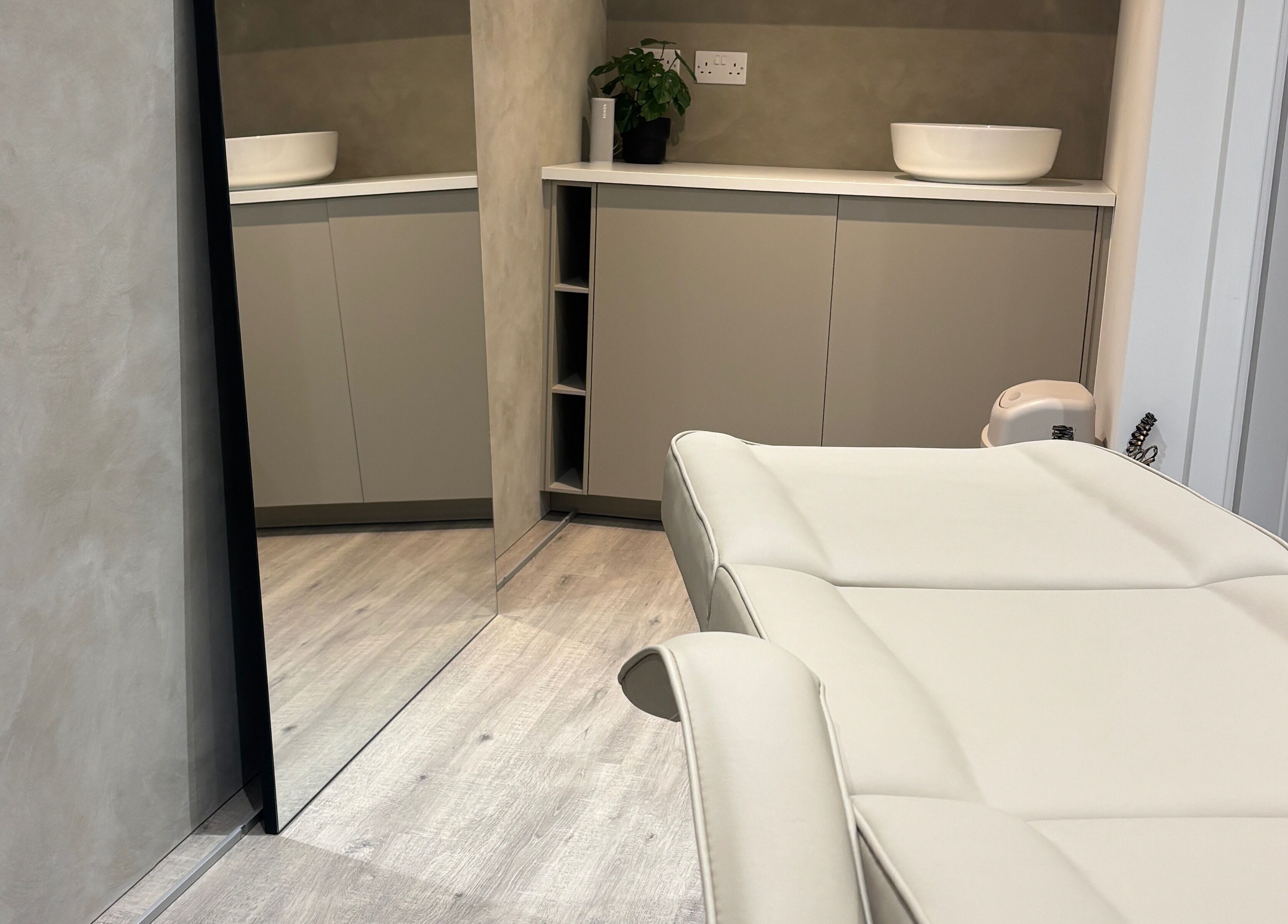 Luxury treatment room at Nóvara, Rochford, England, GB, featuring a modern massage bed and minimalist design.