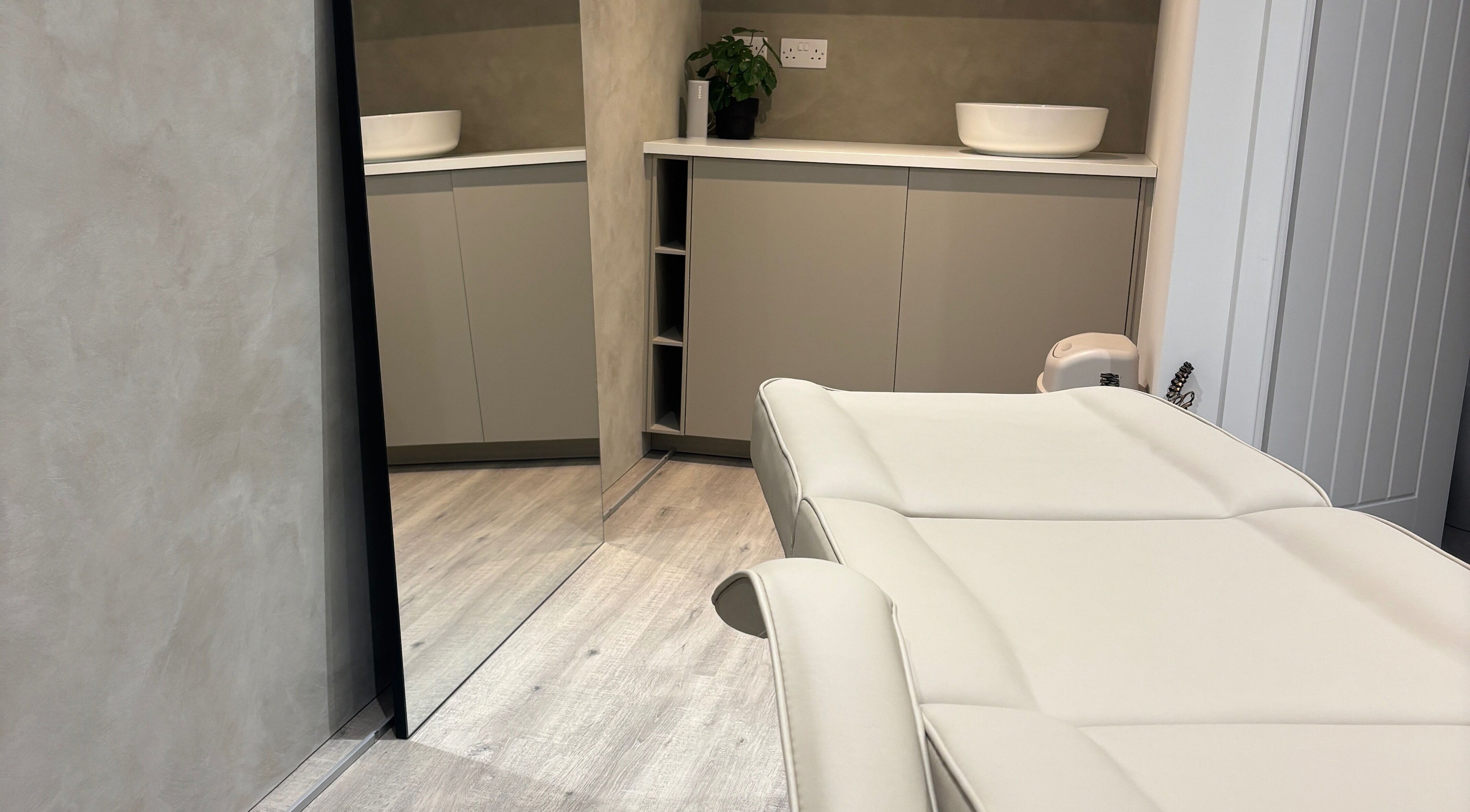 Luxury treatment room at Nóvara, Rochford, England, GB, featuring a modern massage bed and minimalist design.