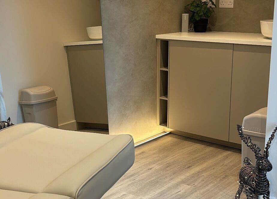 Calming treatment room at Nóvara in Rochford, England, GB with serene decor and warm lighting.