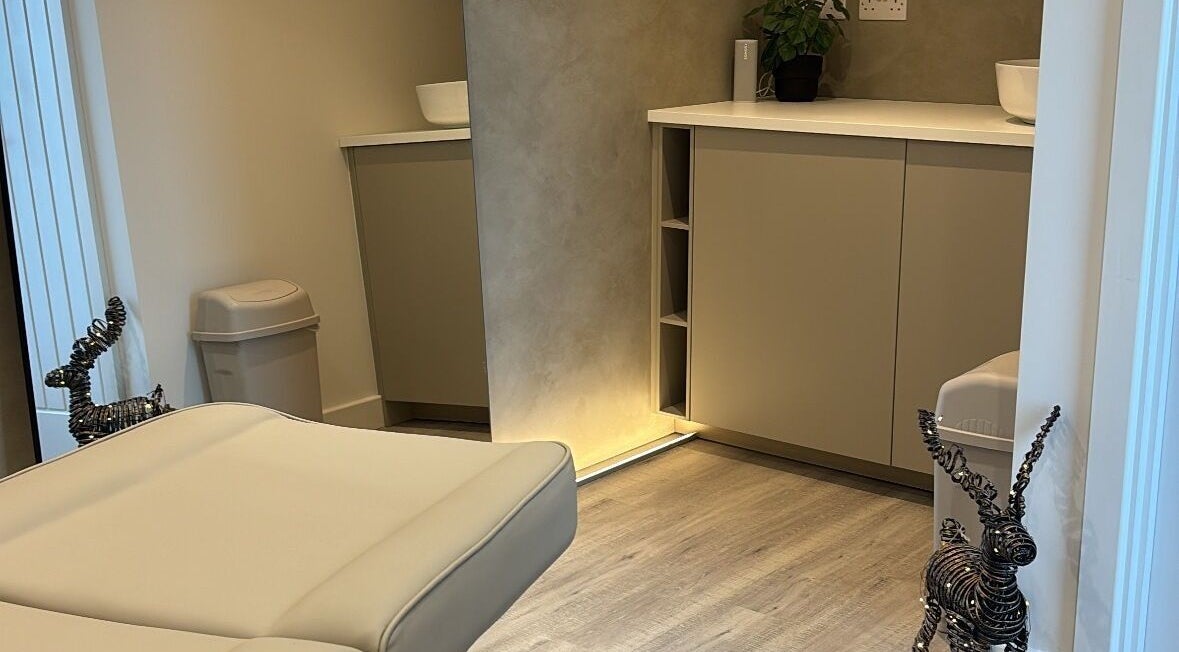 Calming treatment room at Nóvara in Rochford, England, GB with serene decor and warm lighting.