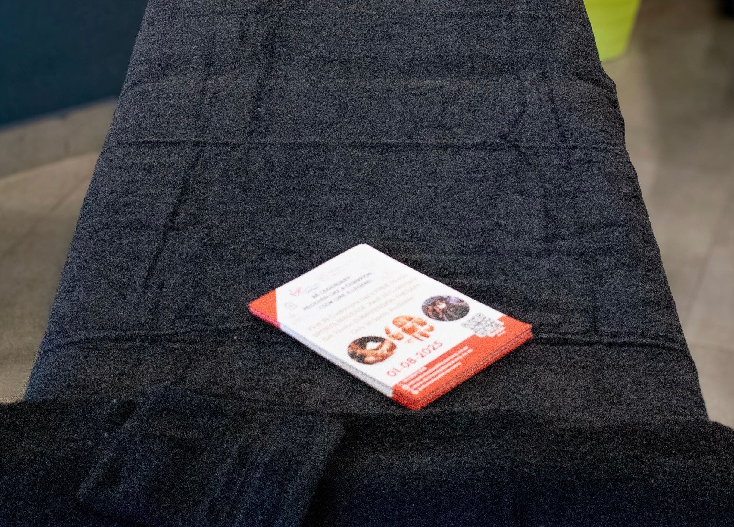 Pamphlet on black massage table at Divine Health Recovery, Randburg, Gauteng, ZA.