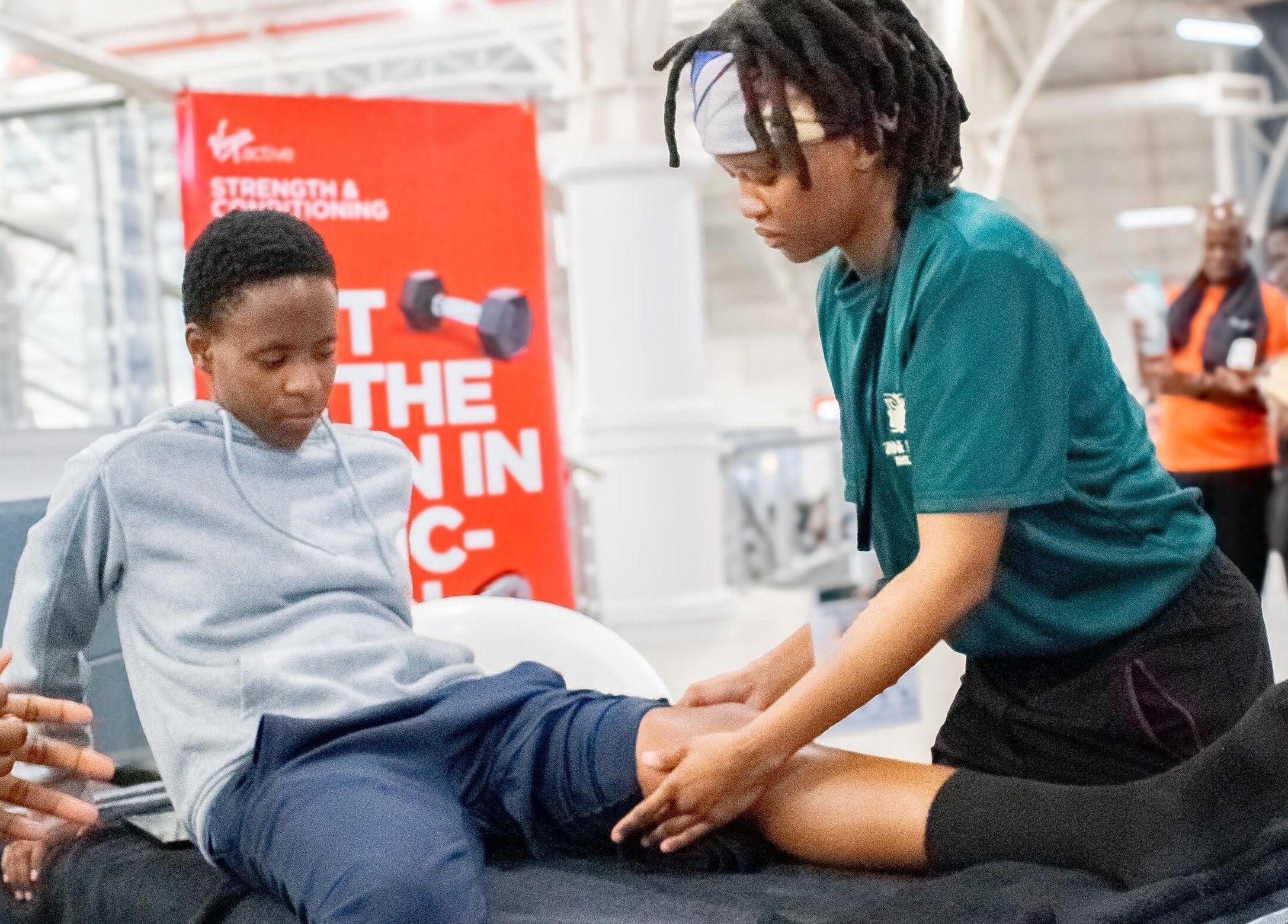 Physiotherapist aids client at Divine Health Recovery Virgin Active 14th Avenue Roodepoort, Roodepoort, Gauteng, ZA.