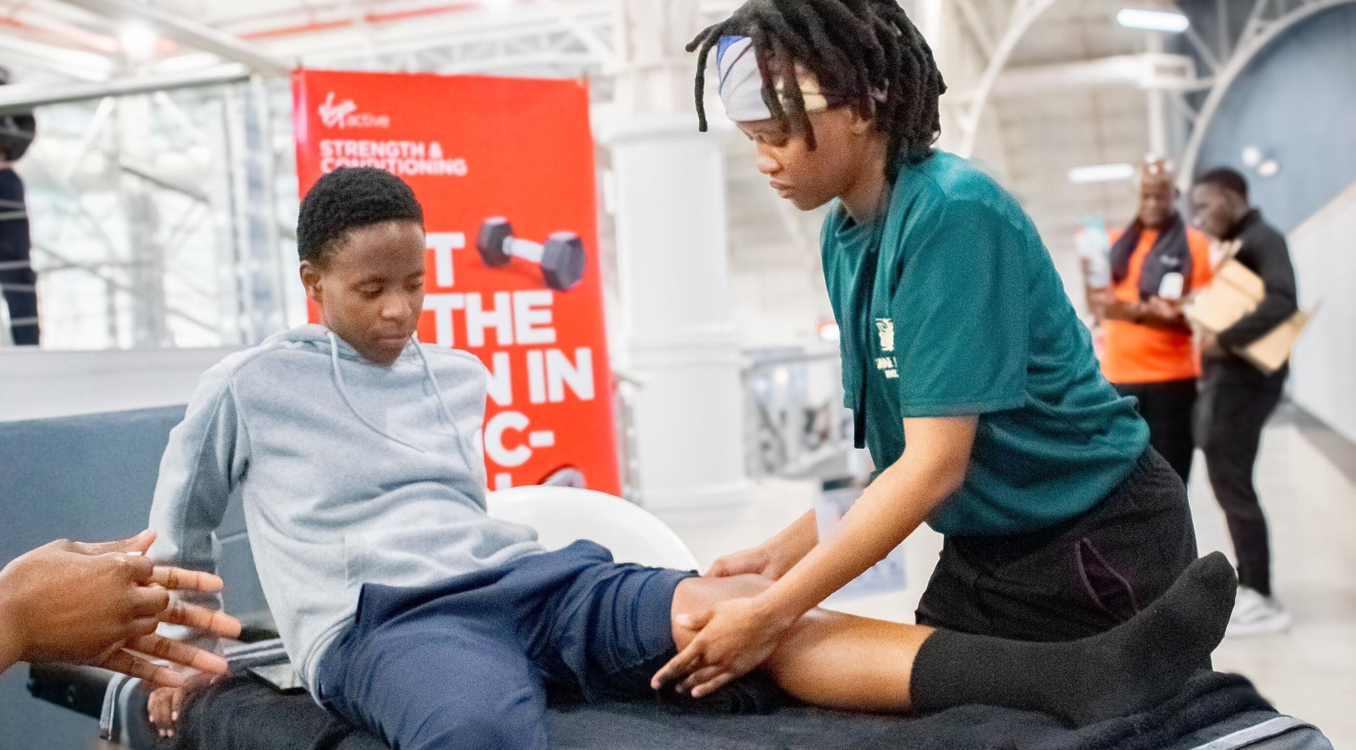 Physiotherapist aids client at Divine Health Recovery Virgin Active 14th Avenue Roodepoort, Roodepoort, Gauteng, ZA.