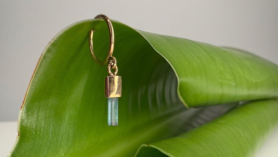 Elegant gold earring with stone on green leaf at Katarza, Split, Splitsko-dalmatinska Županija, HR.