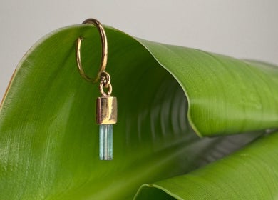 Elegant gold earring with stone on green leaf at Katarza, Split, Splitsko-dalmatinska Županija, HR.