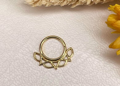 Elegant golden hoop earring with a floral design; available at Katarza, Split, Splitsko-dalmatinska Županija, HR.