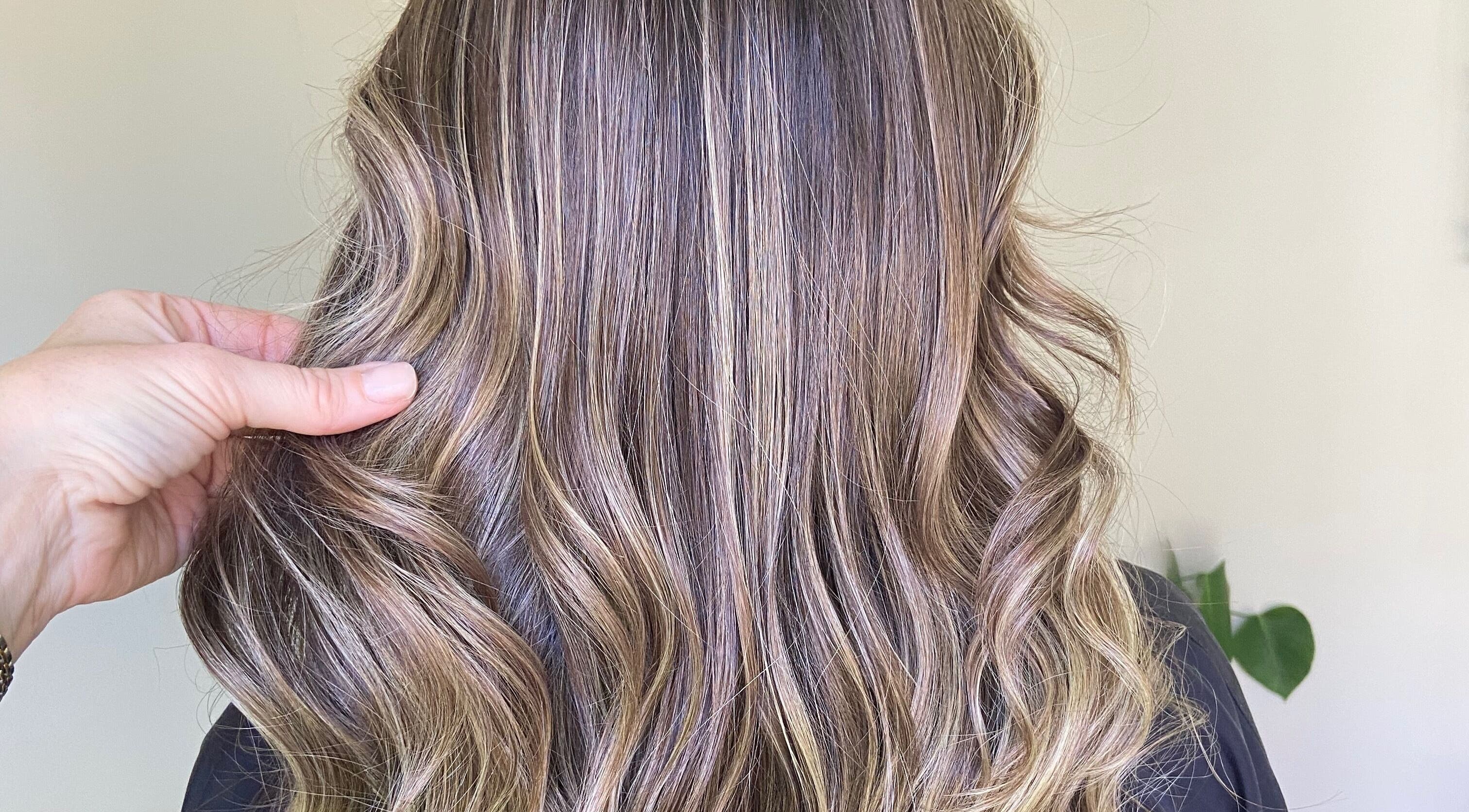 Elegant wavy hair professionally styled at O'Hara Hair, Cardiff, Wales, GB showcasing glossy highlights.