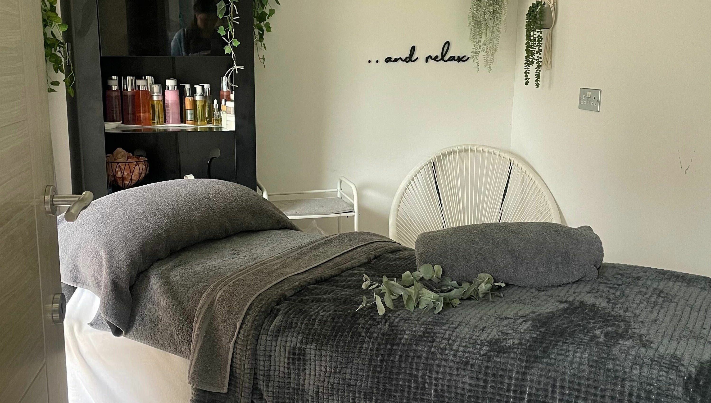 Cozy treatment room at Achill Spa in Knowle, England, GB exudes relaxation with plush decor and calming ambiance.