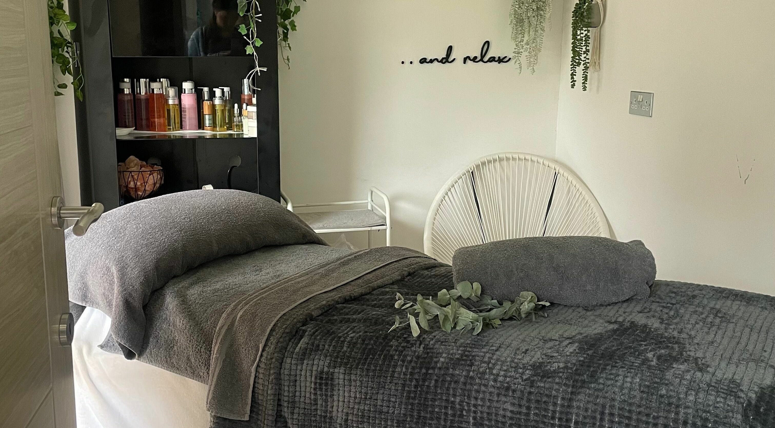 Cozy treatment room at Achill Spa in Knowle, England, GB exudes relaxation with plush decor and calming ambiance.