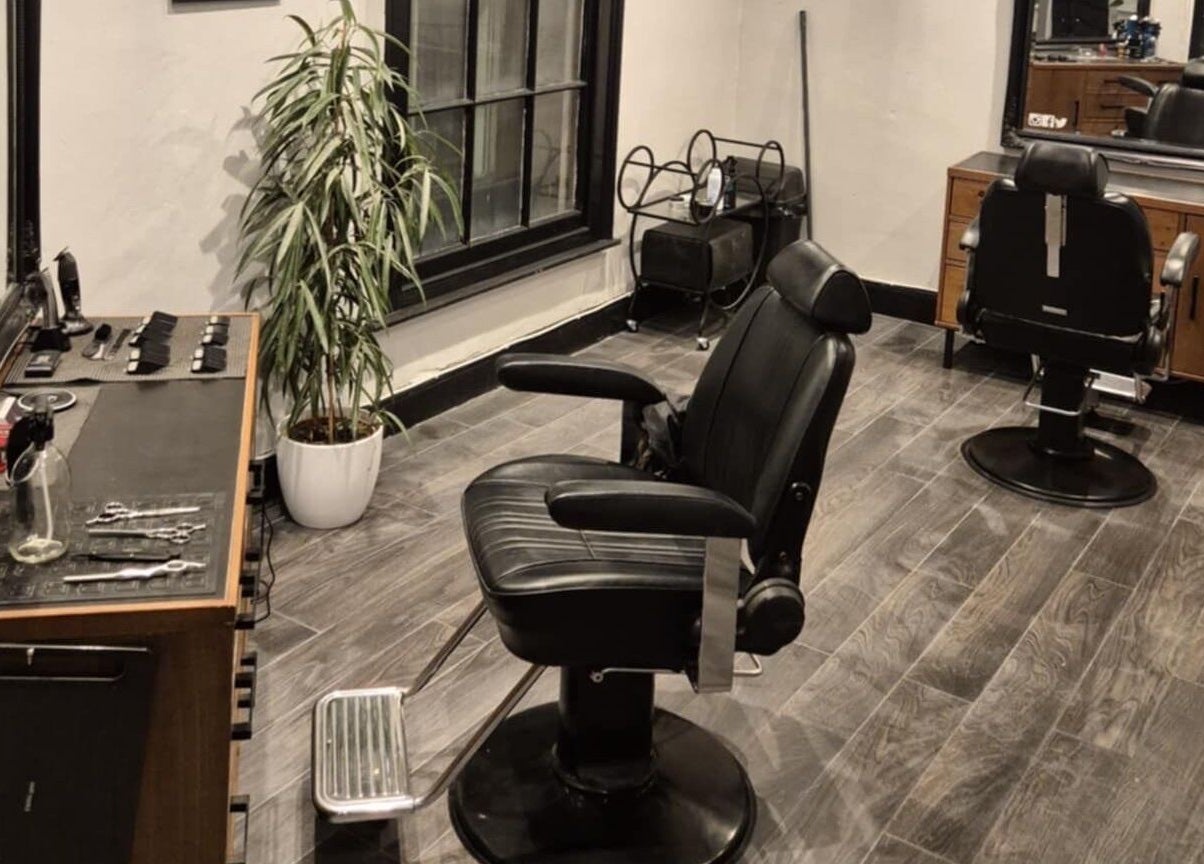 Elegant interior of The Attic Barbershop in Norwich, England, GB featuring modern chairs and stylish decor.