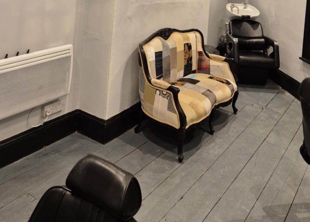 Cozy seating and modern chairs inside The Attic Barbershop, Norwich, England, GB.