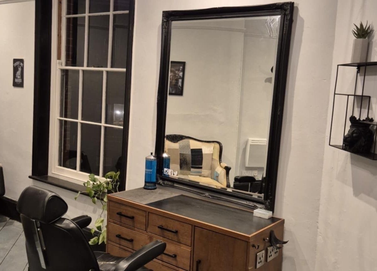 Interior of The Attic Barbershop in Norwich, England, GB, featuring a vintage chair and styling station.
