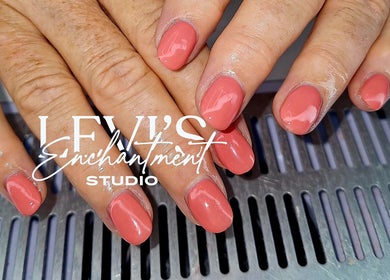 Coral nails manicure at Levi's Enchantment Studio, Torquay, England, GB. Beautifully polished hands.