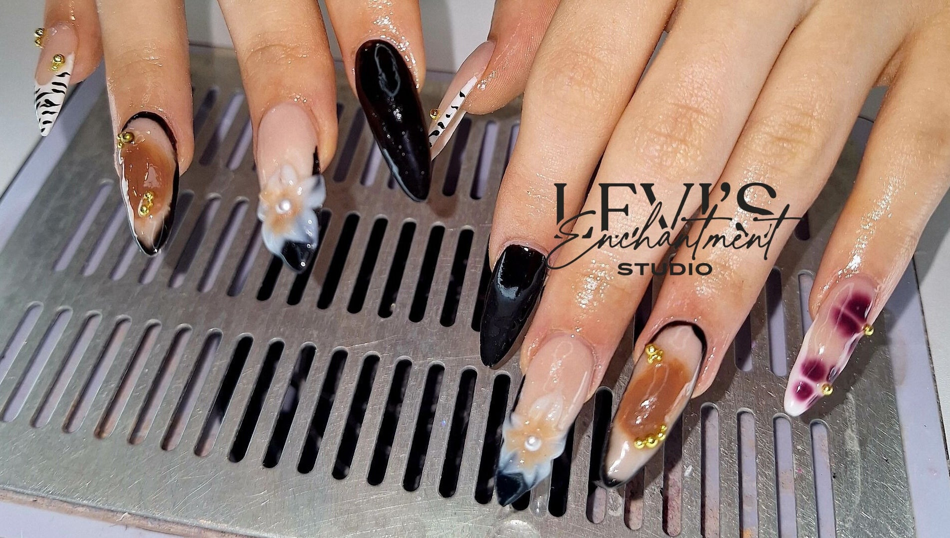 Elegant nail art design from Levi's Enchantment Studio, Torquay, England, GB, showcasing intricate details.