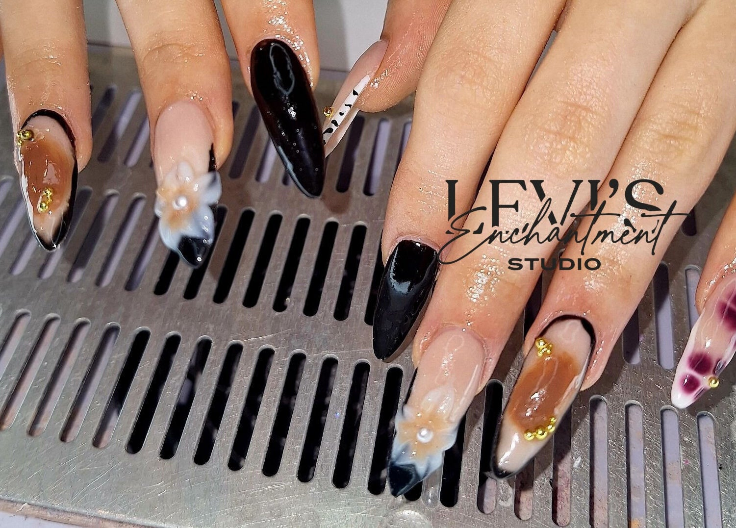 Elegant nail art design from Levi's Enchantment Studio, Torquay, England, GB, showcasing intricate details.