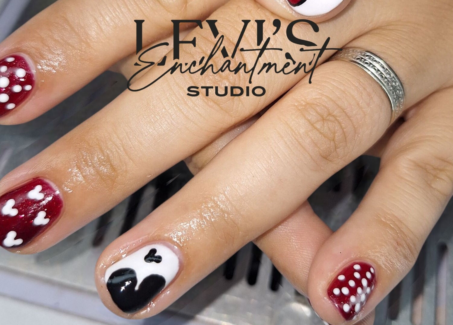 Intricate red and black nail art at Levi's Enchantment Studio, Torquay, England, GB enhancing beauty.